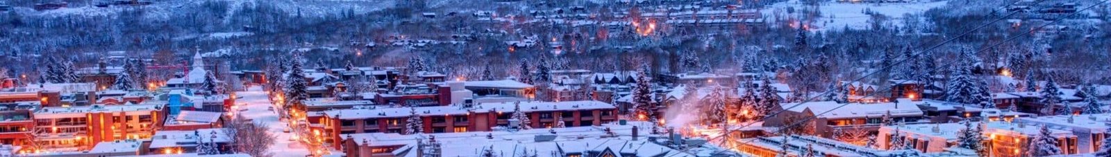 **Texte SEO optimisé :** location de jet privé - Ville enneigée au crépuscule