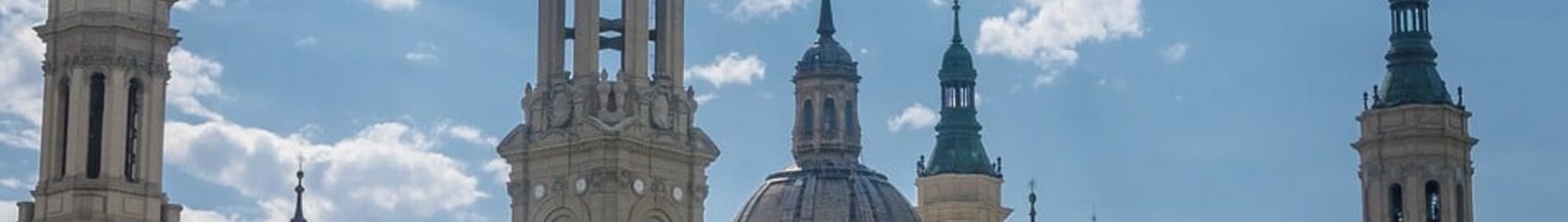 Saragosse : Basilique majestueuse sous un ciel partiellement nuageux.