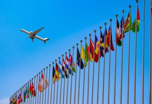 **location jet privé survolant des drapeaux internationaux colorés.**
